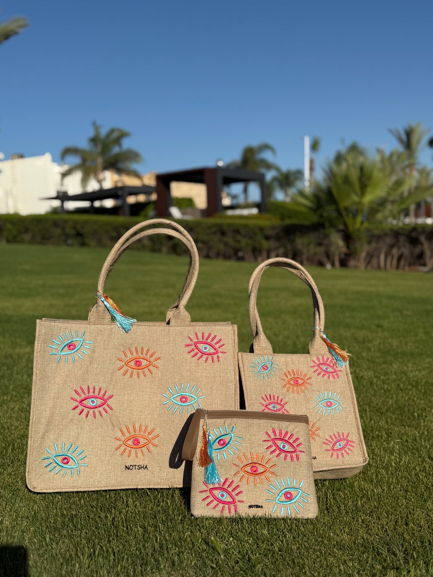 A modern twist on the classic evil eye blending baby blue, orange, and fuchsia.