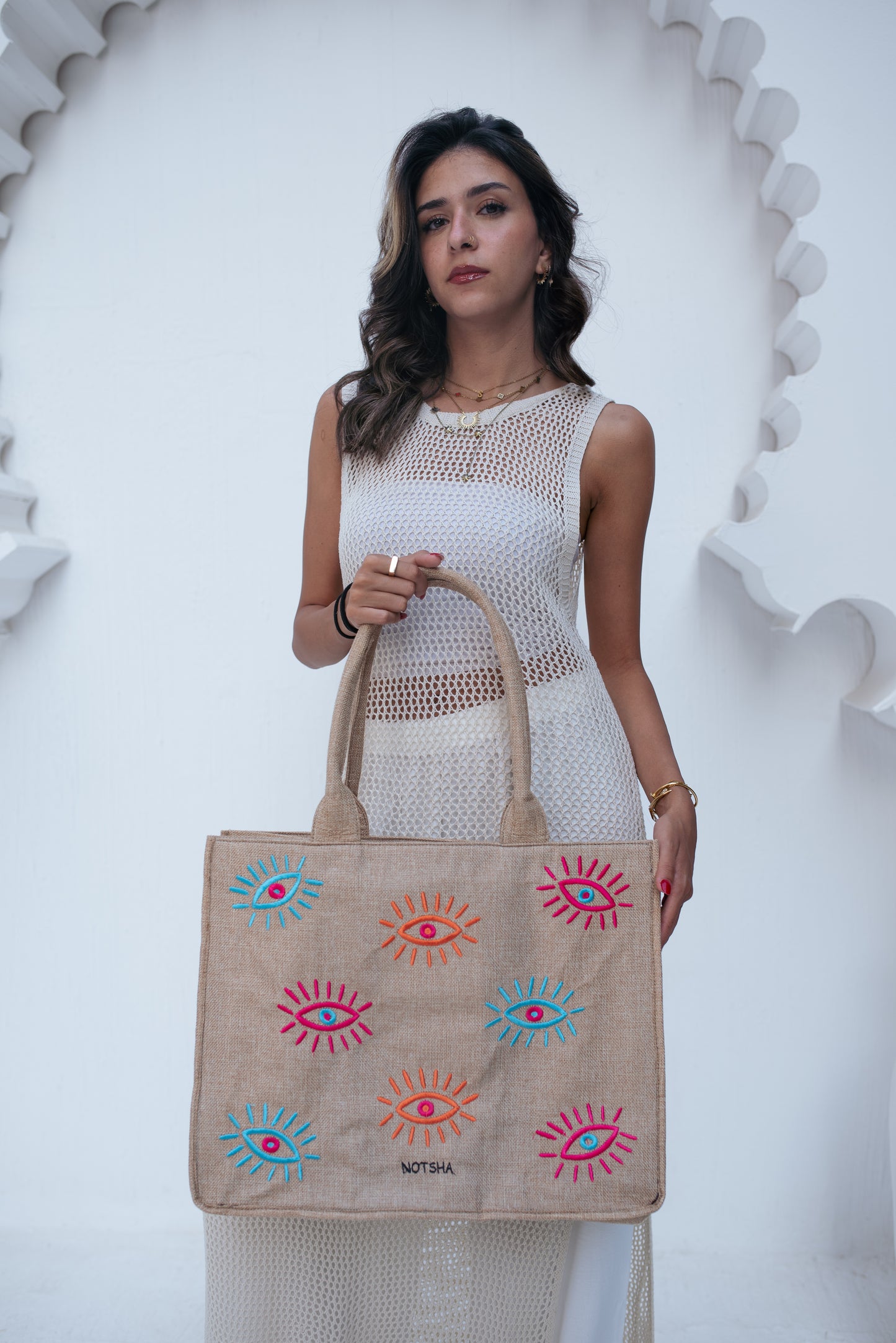 A modern twist on the classic evil eye blending baby blue, orange, and fuchsia.