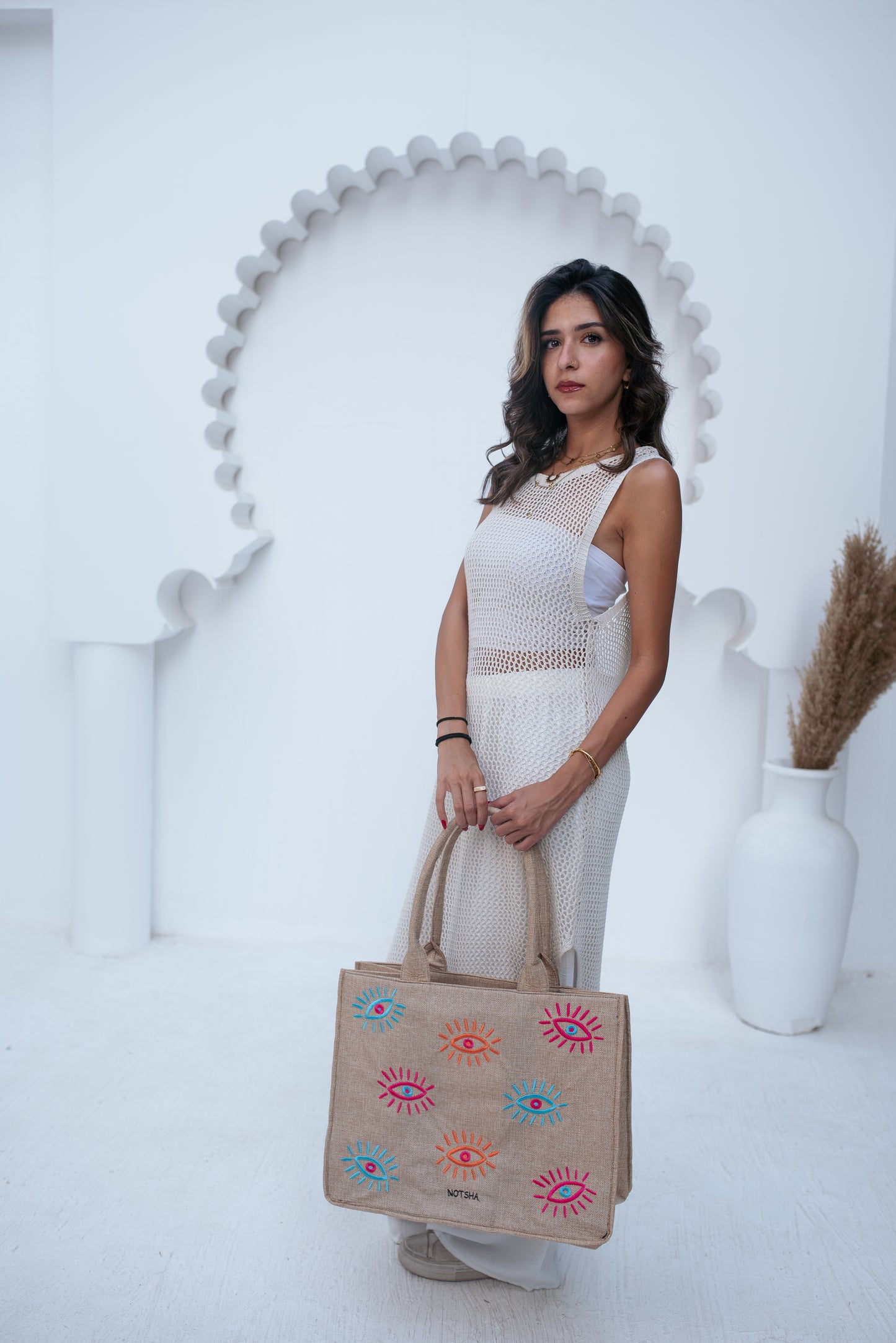 A modern twist on the classic evil eye blending baby blue, orange, and fuchsia.